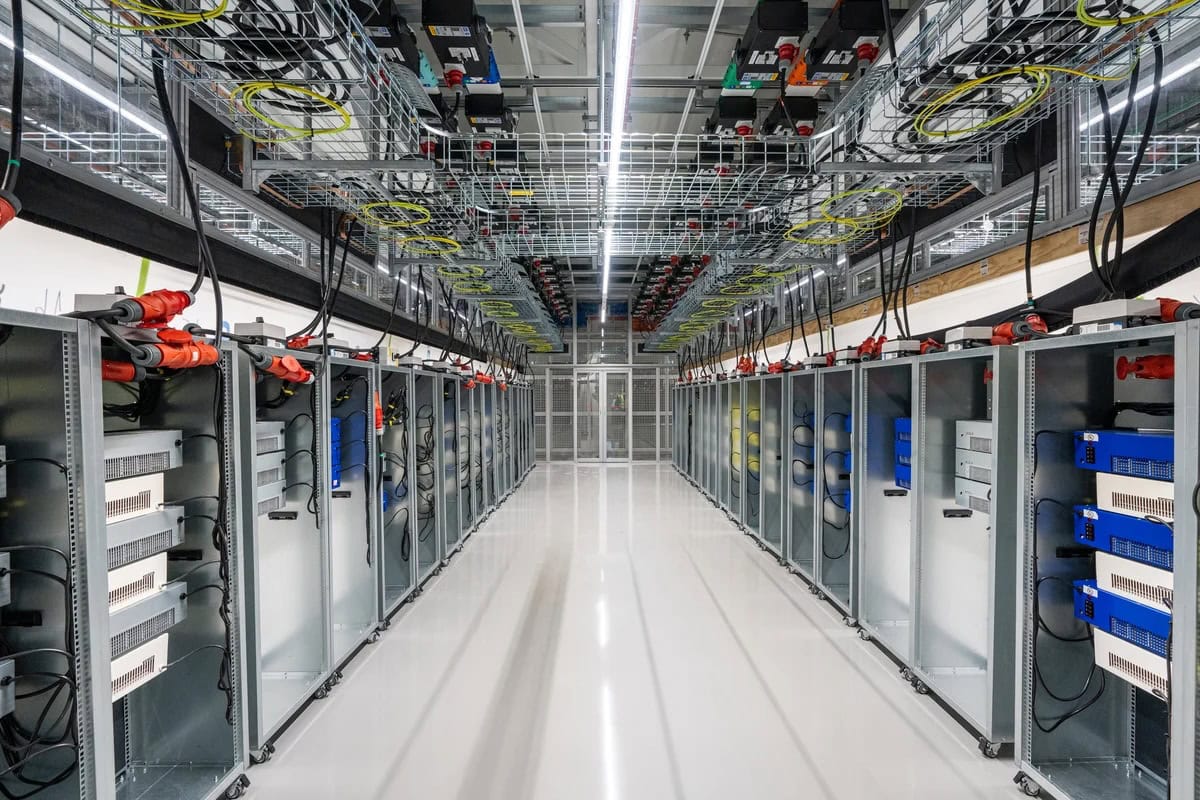 Data centre aisle filled with server racks populated with HeatLoad server emulators for thermal testing
